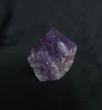 Load image into Gallery viewer, Raw amethyst crystal on a dark background
